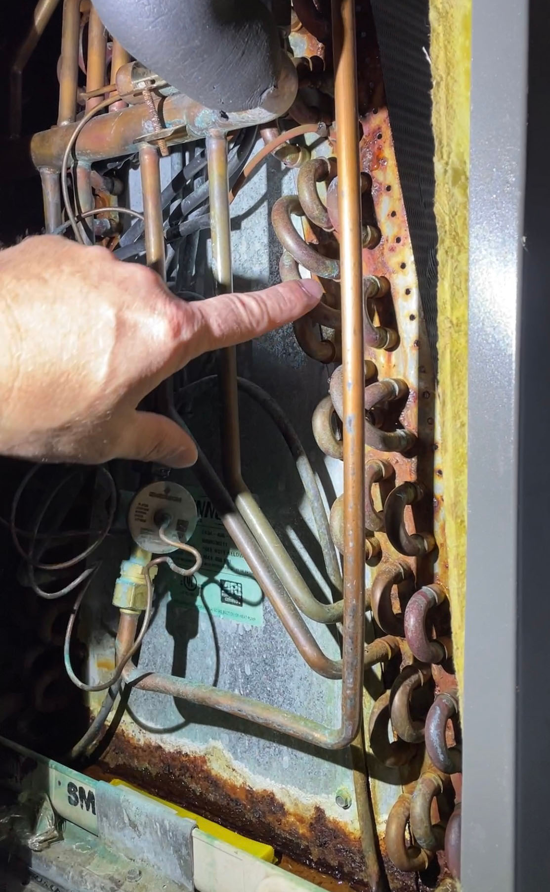 central air conditioner unit with visible rust stains around the edges